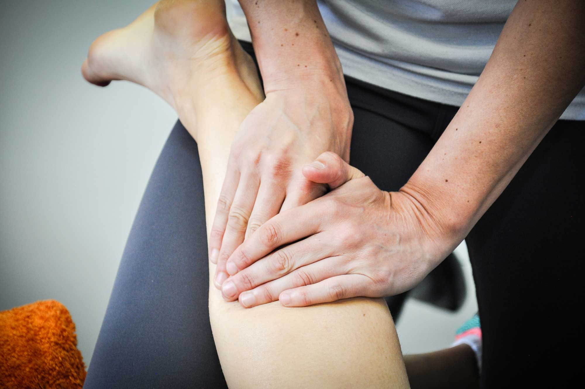Square One - Sports Massage Therapy: Image showing practitioner massaging calf muscle of a patient